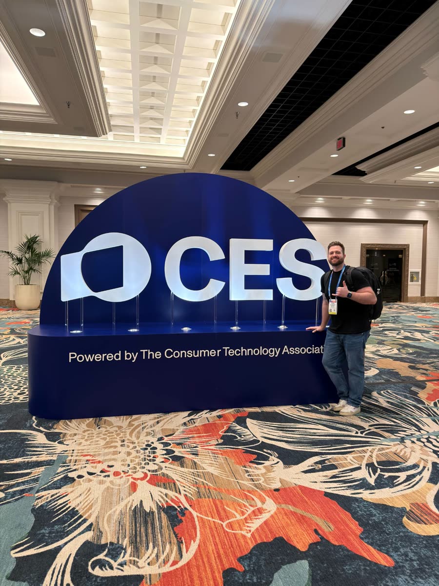 Alex at the CES entrance sign in Las Vegas
